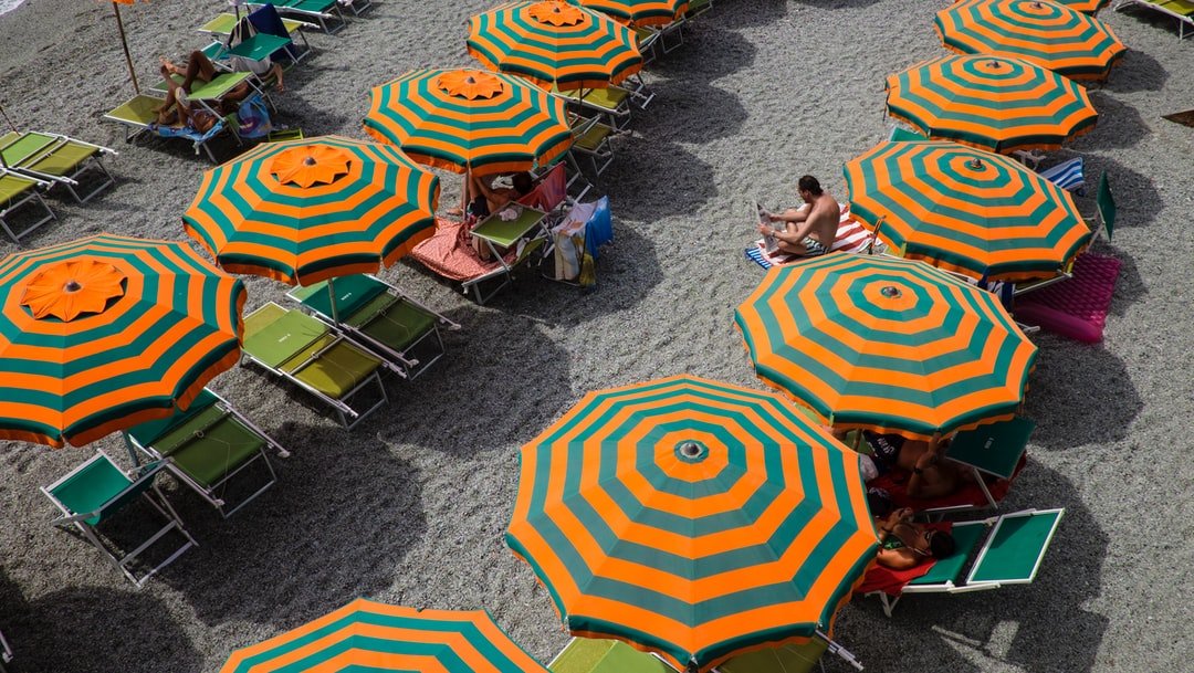 Colourful beach umbrellas seen from above | Cinque Terre in Italy