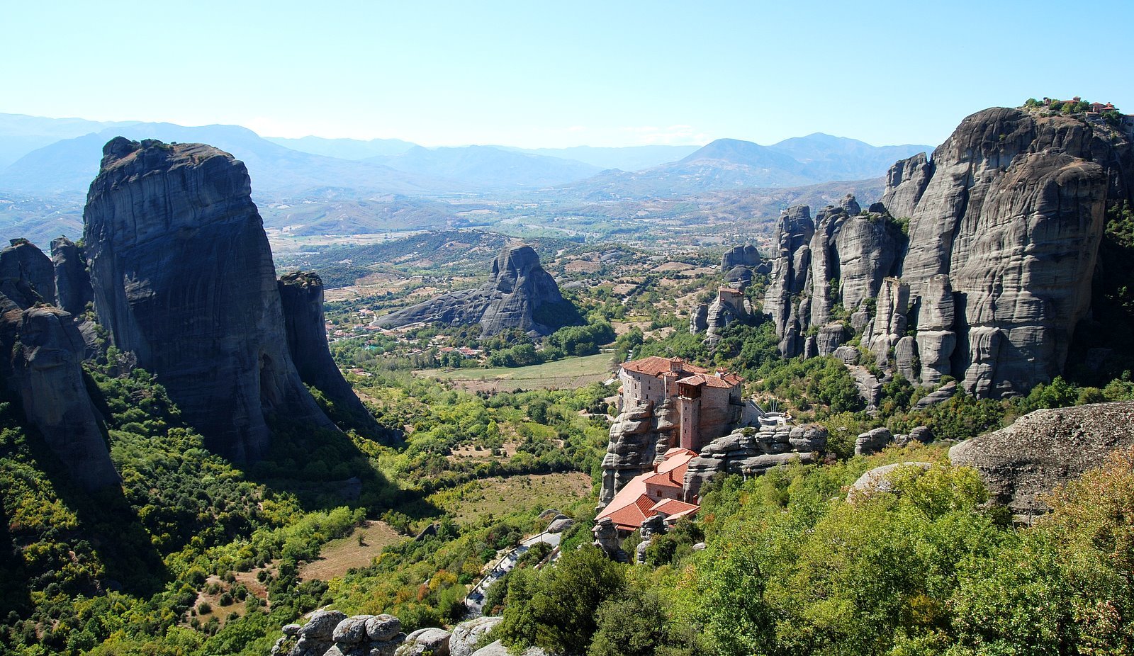 Rousanou monastery in the foreground, Agios Nikolaos behind it and part of the Grand Meteora can be seen in the upper right hand corner of the picture. The village of Kastraki is behind the rocks on the left. | Meteora in Greece