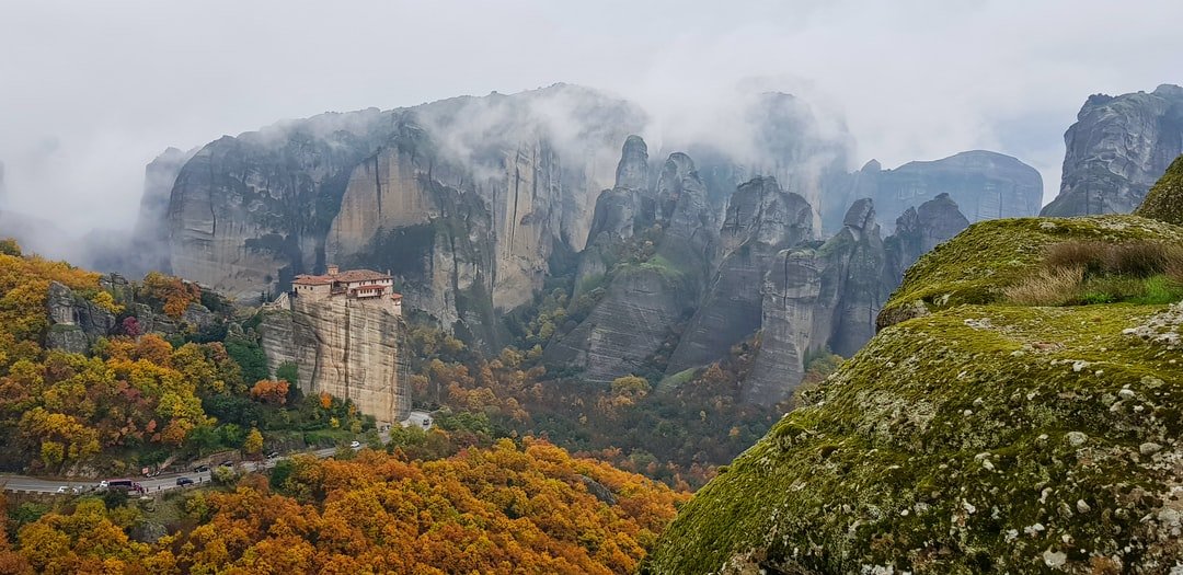 The Meteora (Greek: Μετέωρα, pronounced [meˈteora]) is a rock formation in central Greece hosting one of the largest and most precipitously built complexes of Eastern Orthodox monasteries, second in importance only to Mount Athos.

The six (of an original twenty four) monasteries are built on immense natural pillars and hill-like rounded boulders that dominate the local area. It is located near the town of Kalambaka at the northwestern edge of the Plain of Thessaly near the Pineios river and Pindus Mountains.

The name means “lofty”, “elevated”, and is etymologically related to meteor. | Meteora in Greece