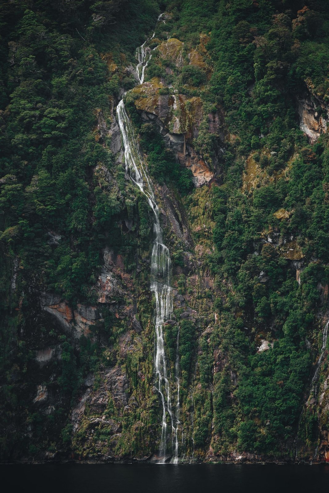 On the way into Milford Sound, NZ, we spotted many waterfalls trickling down the steep mountainsides. Most leaving amazing trails as the water made its way down. | Milford Sound in New Zealand