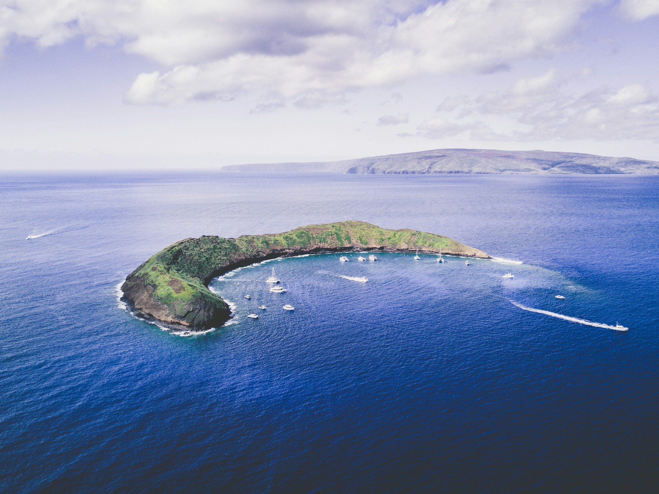 We hopped on a tour boat and ventured four miles off the coast to Molokini Crater. Some of the best snorkeling in Maui! Of course as soon as we got there, I had to ask the captain about flying my drone before diving in to join the others. | Maui in United States